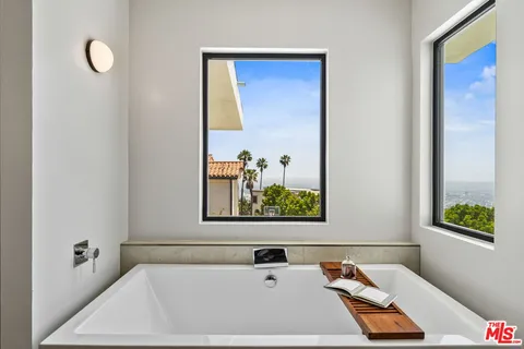 a room with a bed and painting on the wall