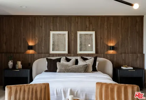 a bedroom with a large bed and a balcony