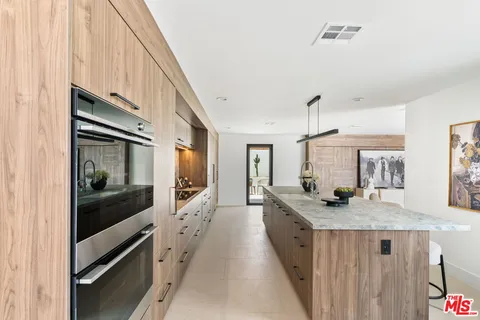a kitchen with granite countertop a stove and a sink