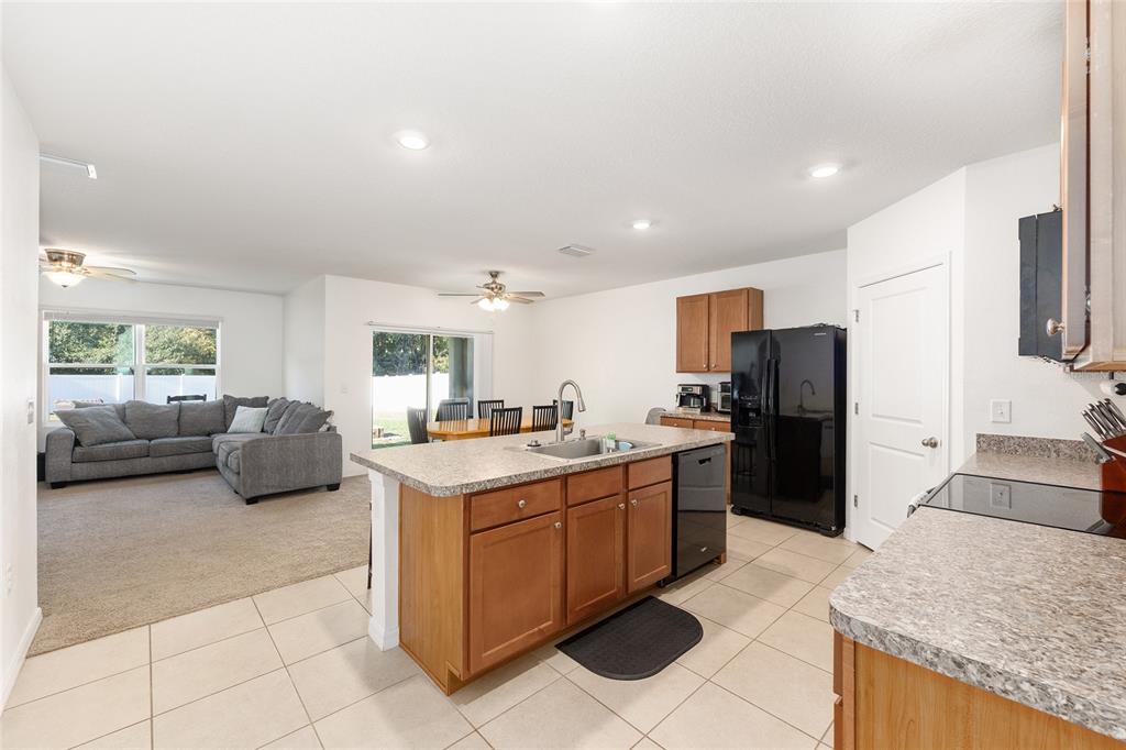 2530 Northeast 42nd Road Ocala, FL 34470 - Photo 14 of 61 a kitchen with stainless steel appliances granite countertop a sink stove and refrigerator