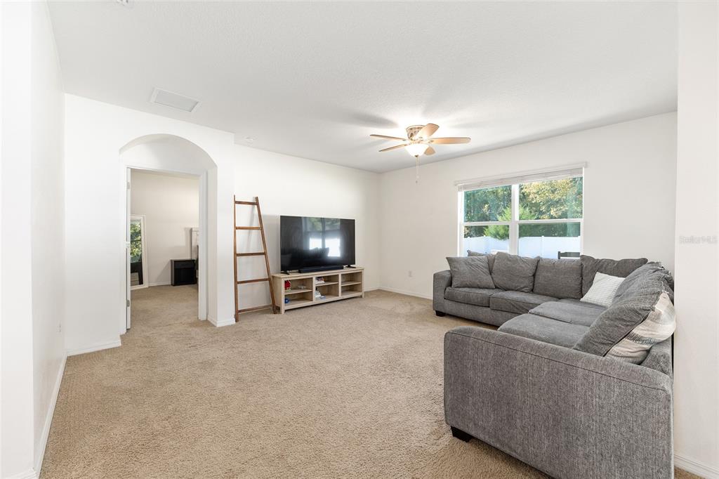 2530 Northeast 42nd Road Ocala, FL 34470 - Photo 18 of 61 a living room with furniture and a flat screen tv