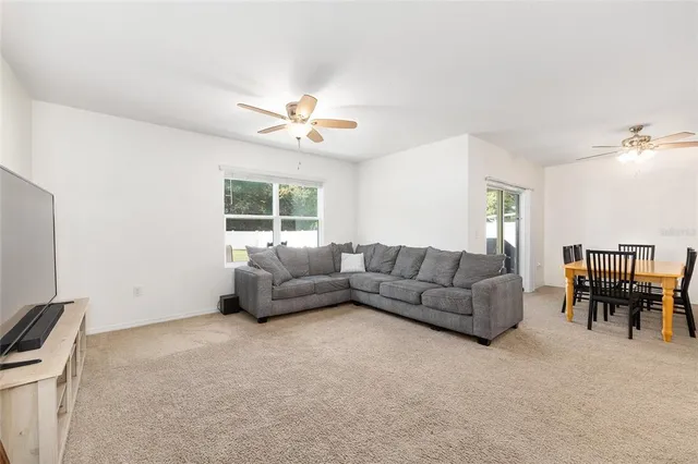 a bedroom with a bed and a ceiling fan