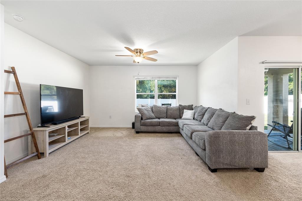 2530 Northeast 42nd Road Ocala, FL 34470 - Photo 20 of 61 a living room with furniture and a flat screen tv