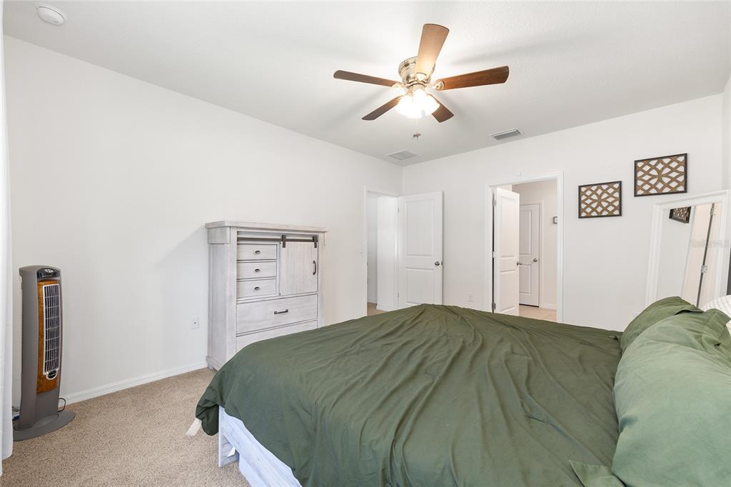 2530 Northeast 42nd Road Ocala, FL 34470 - Photo 24 of 61 a bedroom with a bed and a ceiling fan