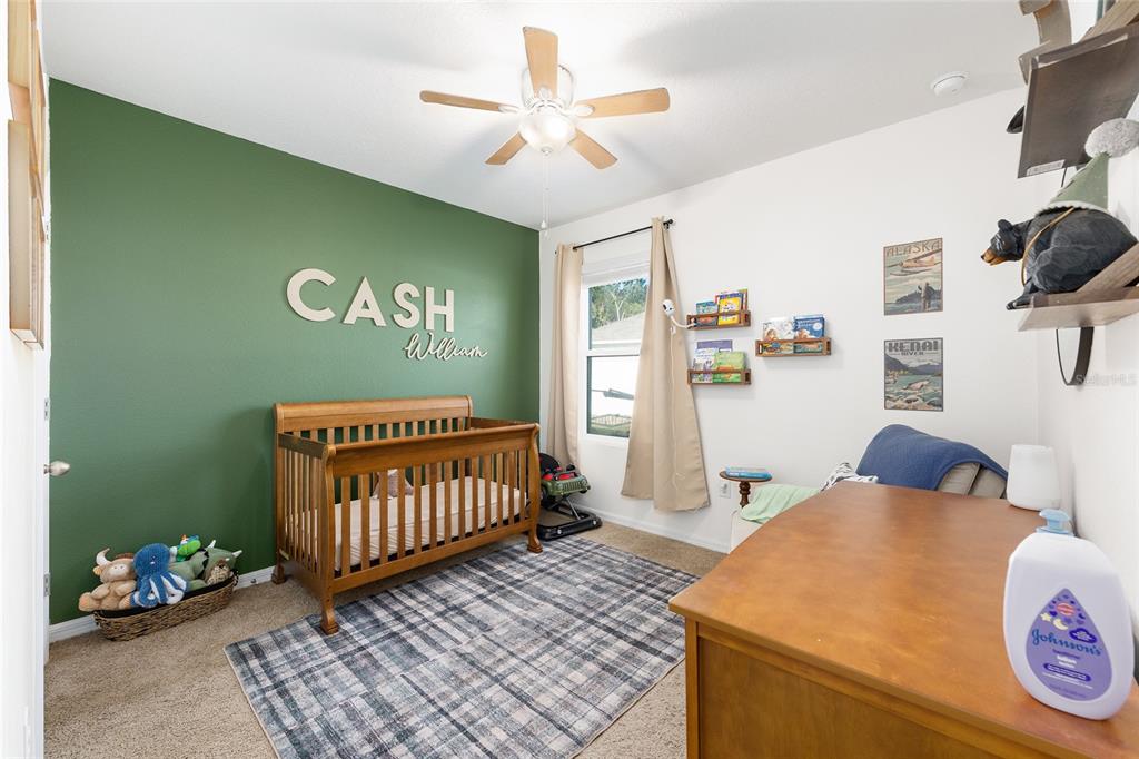 2530 Northeast 42nd Road Ocala, FL 34470 - Photo 29 of 61 a bedroom with furniture and a baby crib