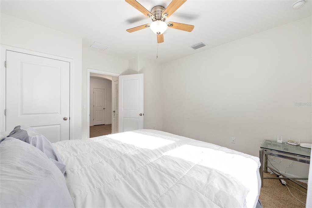 2530 Northeast 42nd Road Ocala, FL 34470 - Photo 32 of 61 a bedroom with a bed and a chandelier