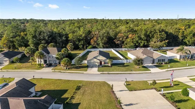 an aerial view of residential houses with outdoor space