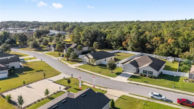 an aerial view of residential houses with outdoor space