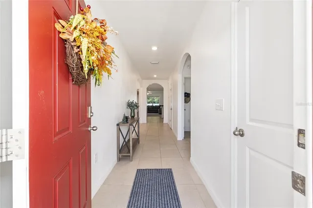 a kitchen with stainless steel appliances granite countertop a stove top oven a sink a dining table and chairs