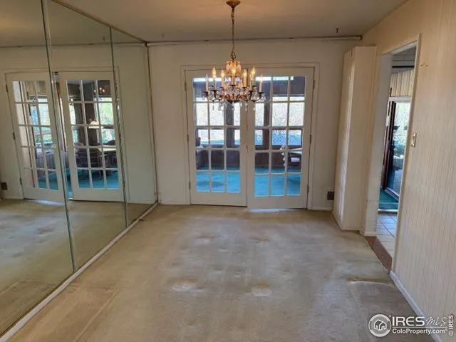 a view of an empty room with glass door