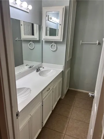 a bathroom with a sink a mirror and vanity