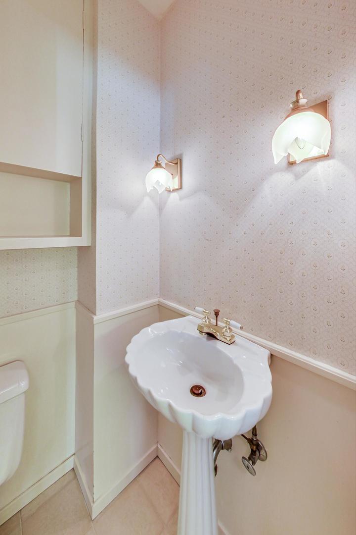 22 Timber Lane Northbrook, IL 60062 - Photo 15 of 41 a bathroom with a sink a toilet and a mirror