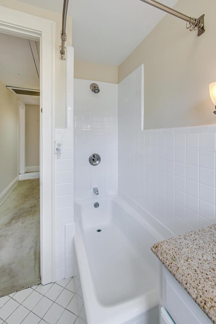 22 Timber Lane Northbrook, IL 60062 - Photo 18 of 41 a bathroom with a granite countertop bathtub shower and vanity
