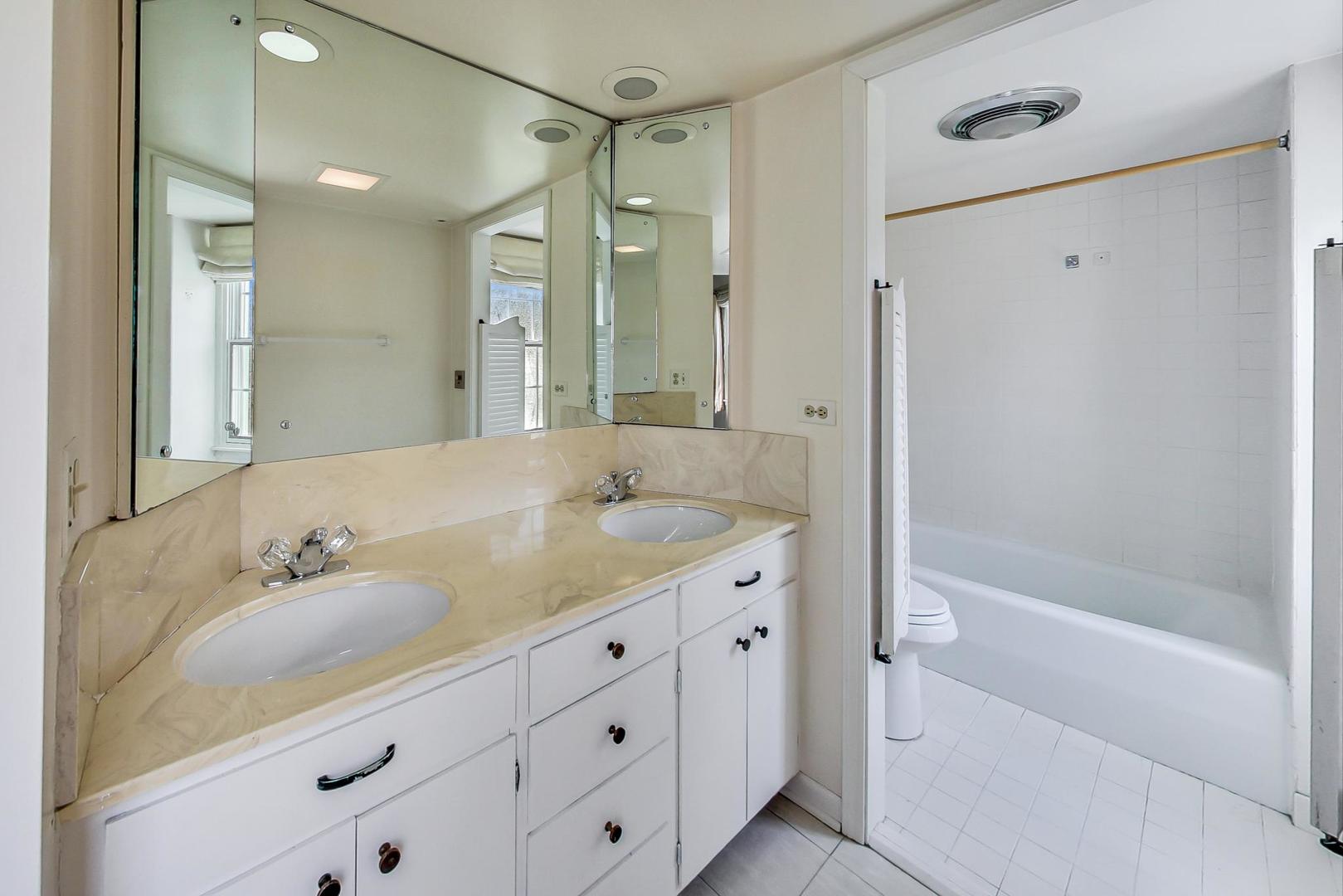 22 Timber Lane Northbrook, IL 60062 - Photo 20 of 41 a bathroom with a granite countertop sink mirror and a bathtub