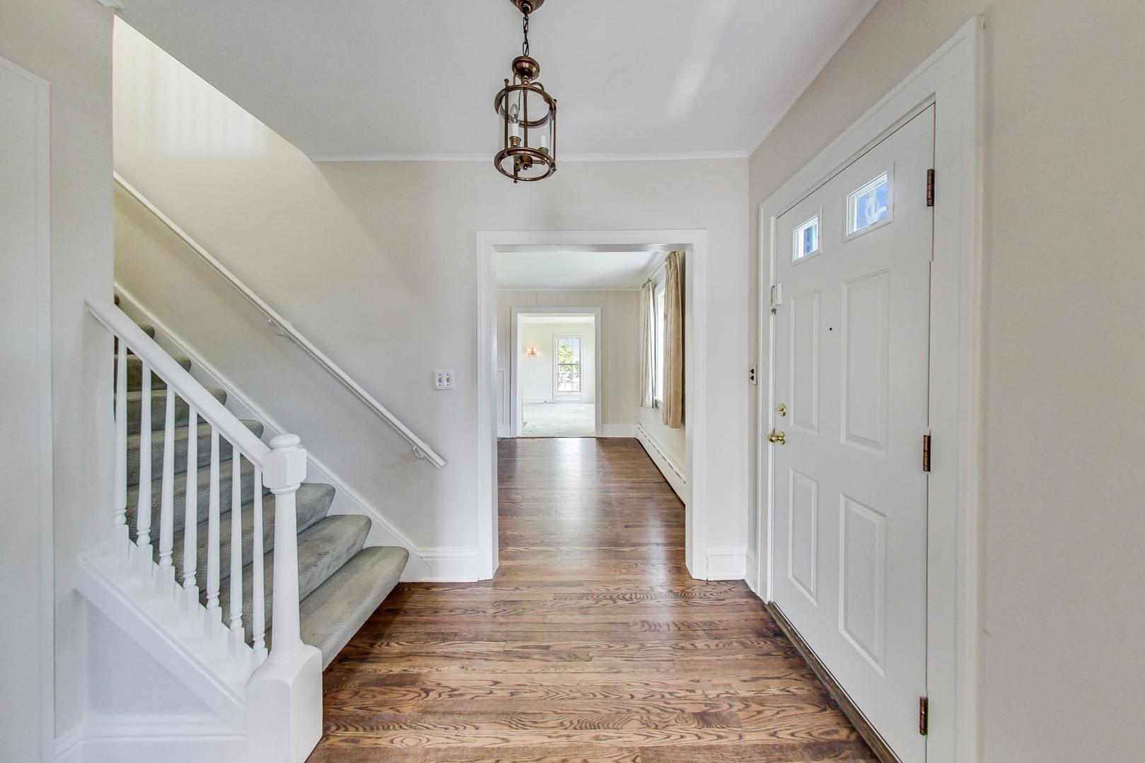 22 Timber Lane Northbrook, IL 60062 - Photo 3 of 41 a view of a hallway with wooden floor and staircase