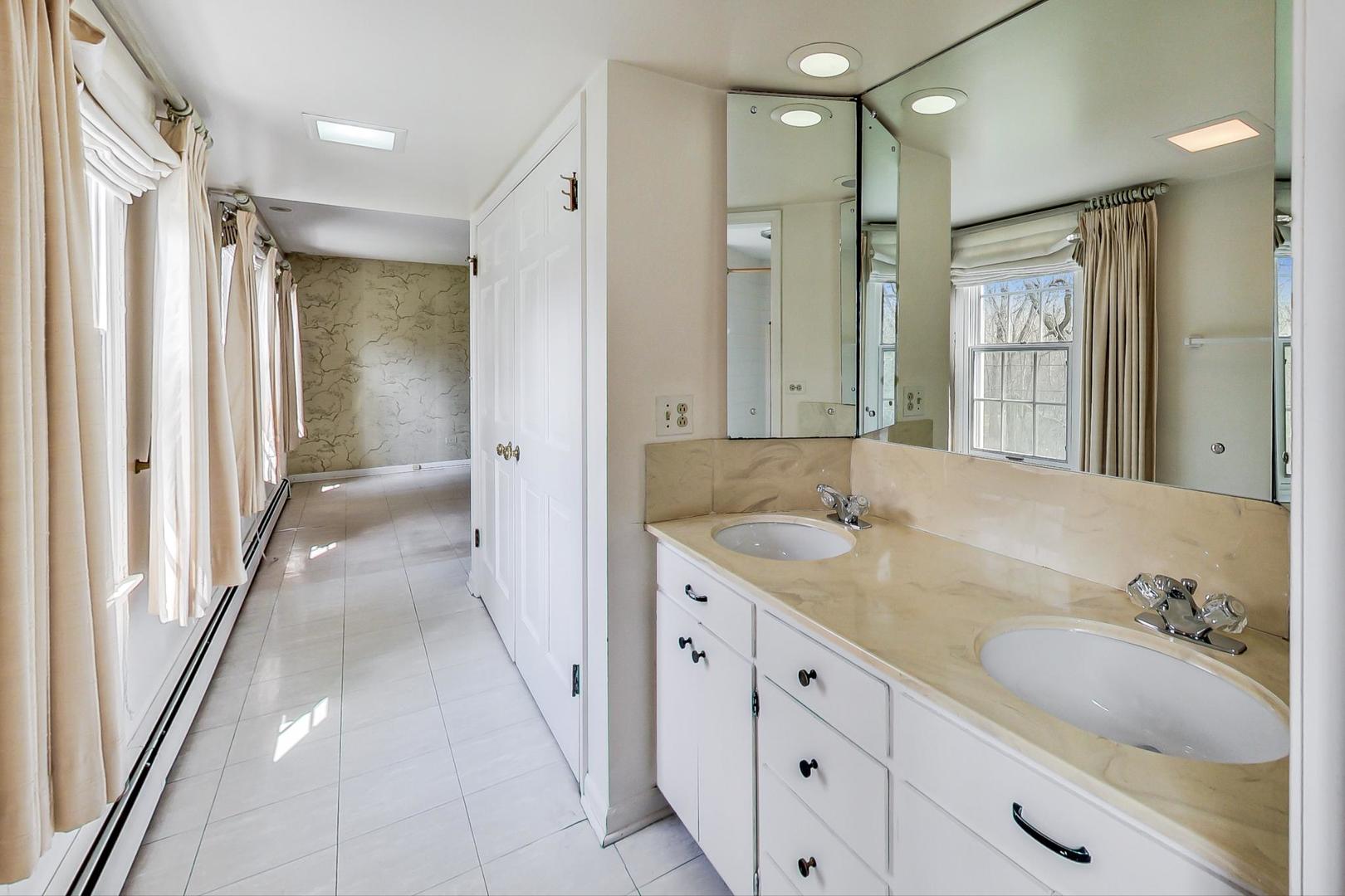 22 Timber Lane Northbrook, IL 60062 - Photo 21 of 41 a spacious bathroom with a granite countertop sink shower and a mirror