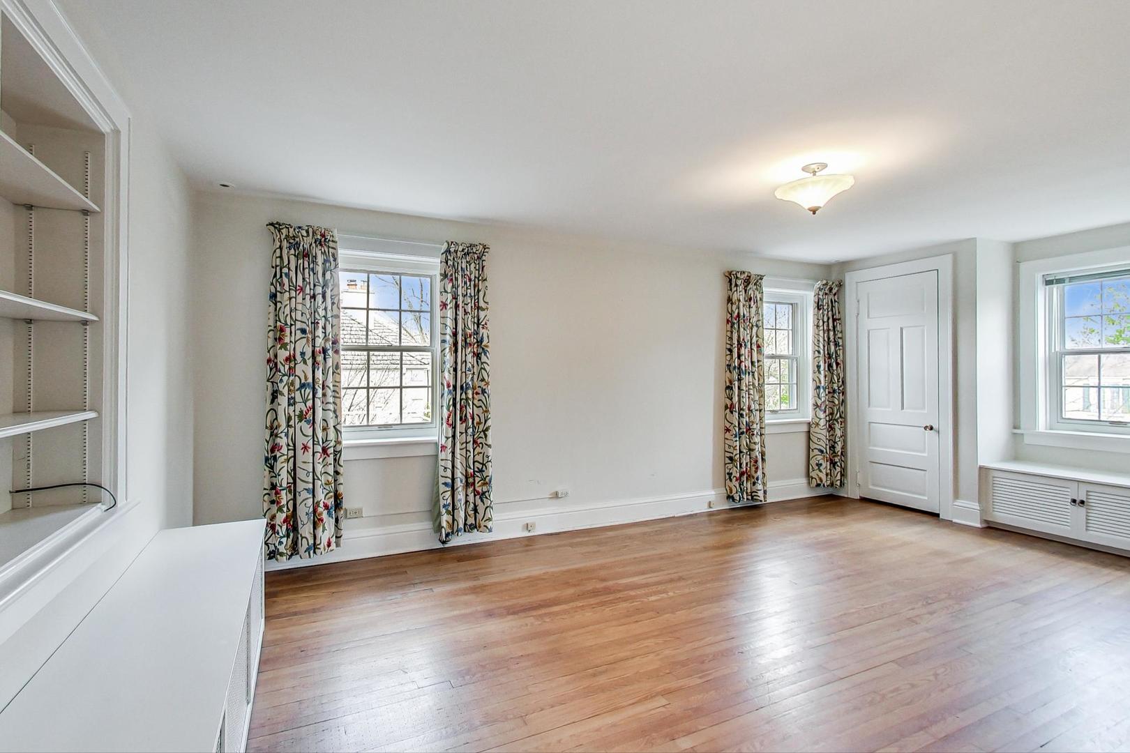 22 Timber Lane Northbrook, IL 60062 - Photo 24 of 41 an empty room with wooden floor and windows