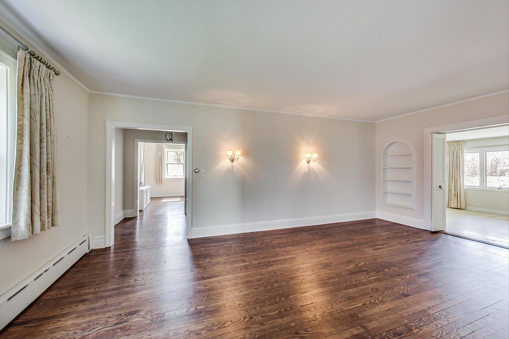 22 Timber Lane Northbrook, IL 60062 - Photo 5 of 41 an empty room with wooden floor and windows