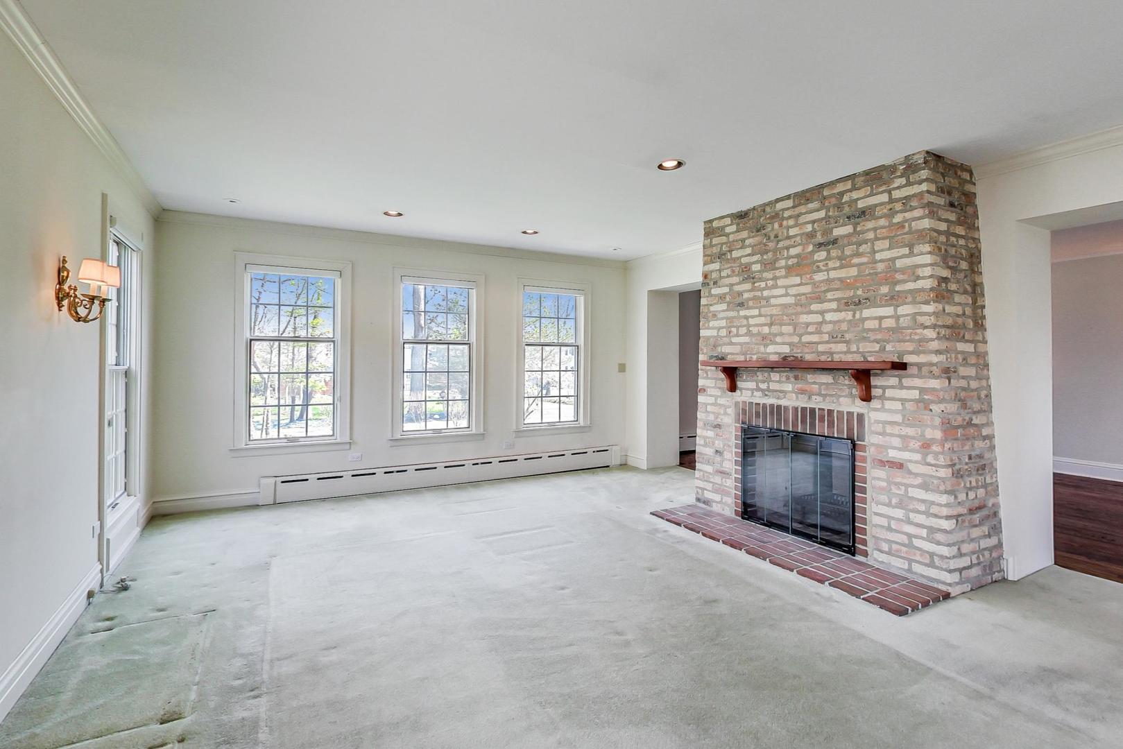 22 Timber Lane Northbrook, IL 60062 - Photo 7 of 41 an empty room with windows and fireplace