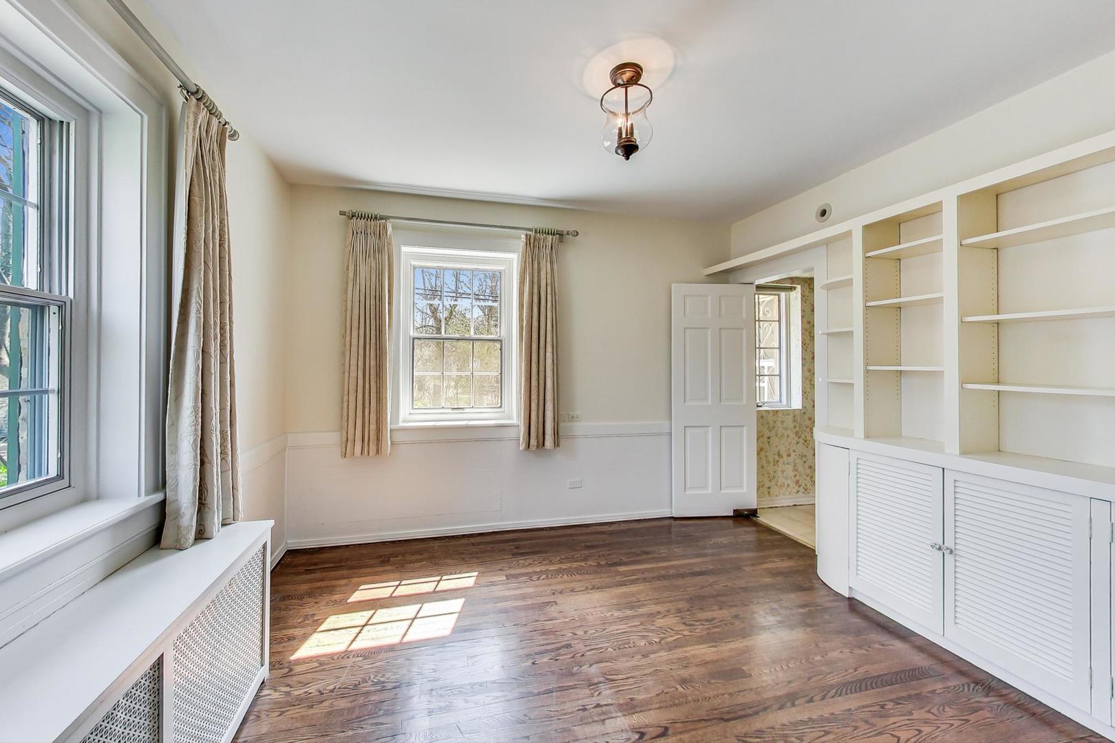 22 Timber Lane Northbrook, IL 60062 - Photo 8 of 41 a view of an empty room with wooden floor and a window