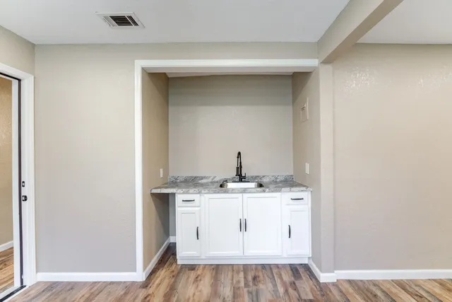 a view of cabinets with wooden floor