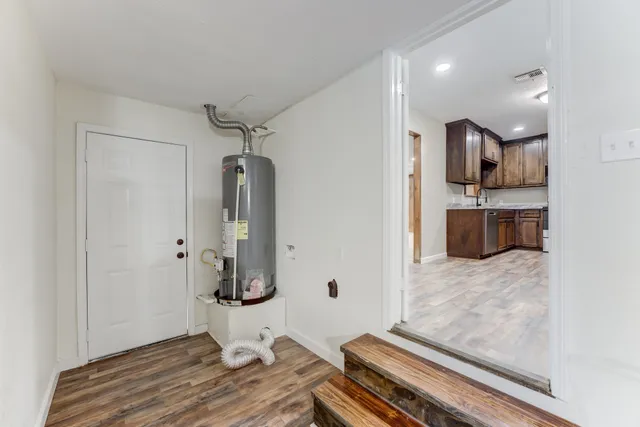 a room with wooden floor and cabinets