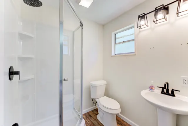 a bathroom with a toilet sink and mirror