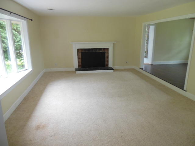 4645 Grandin Road Southwest Roanoke, VA 24018 - Photo 2 of 23 an empty room with a fireplace and a window