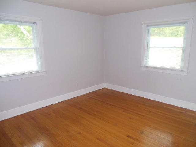 4645 Grandin Road Southwest Roanoke, VA 24018 - Photo 15 of 23 an empty room with wooden floor and windows