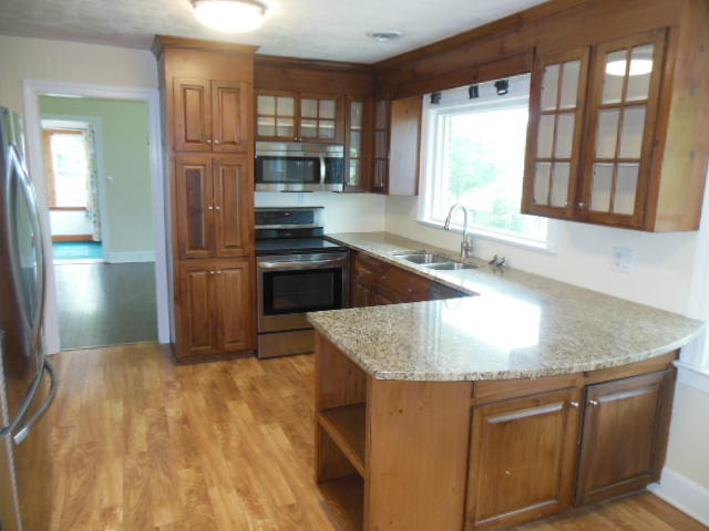 4645 Grandin Road Southwest Roanoke, VA 24018 - Photo 3 of 23 a kitchen with stainless steel appliances granite countertop a sink a stove and a refrigerator