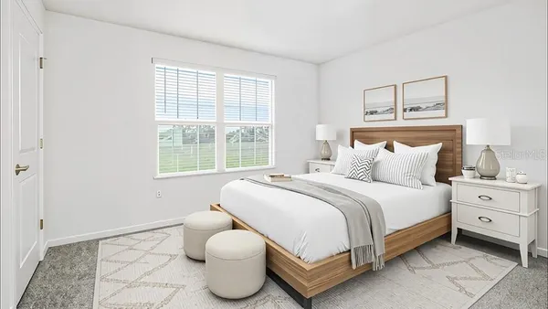 a spacious bedroom with a bed and a window