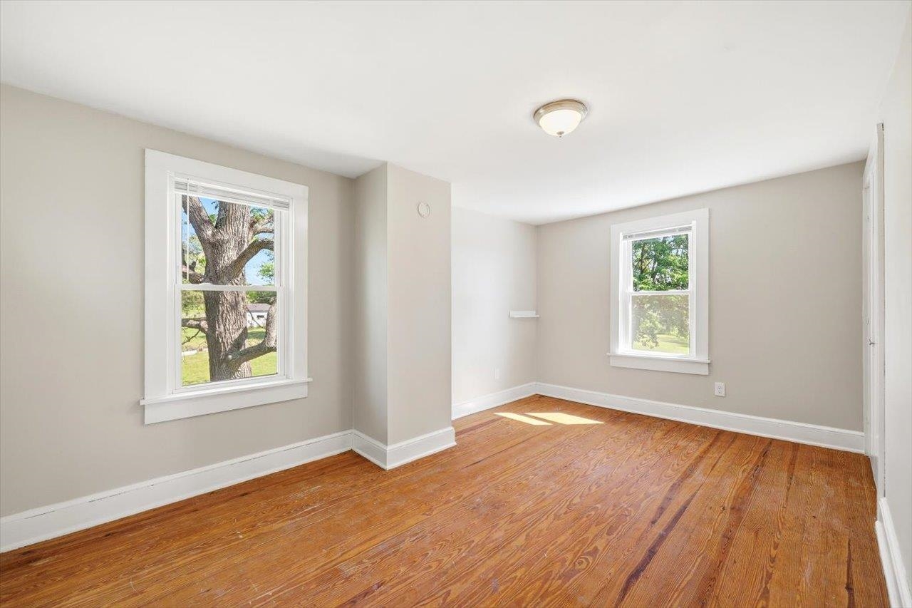 5096 Battlefield Road Harrisonburg, VA 22801 - Photo 19 of 38 an empty room with wooden floor and windows