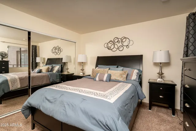 a bed room with two bed and a night stand