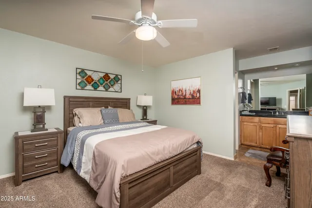 a bedroom with a bed and a chandelier