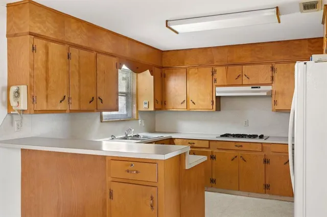 a kitchen with stainless steel appliances granite countertop a sink and cabinets