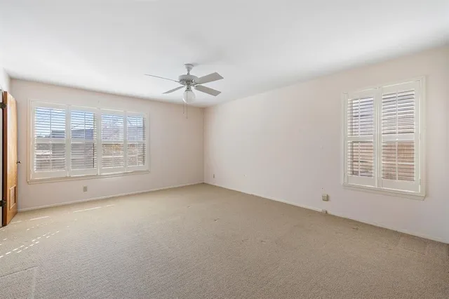 an empty room with a empty space and windows