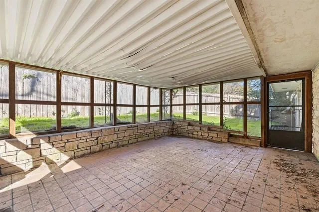 a view of an empty room with windows