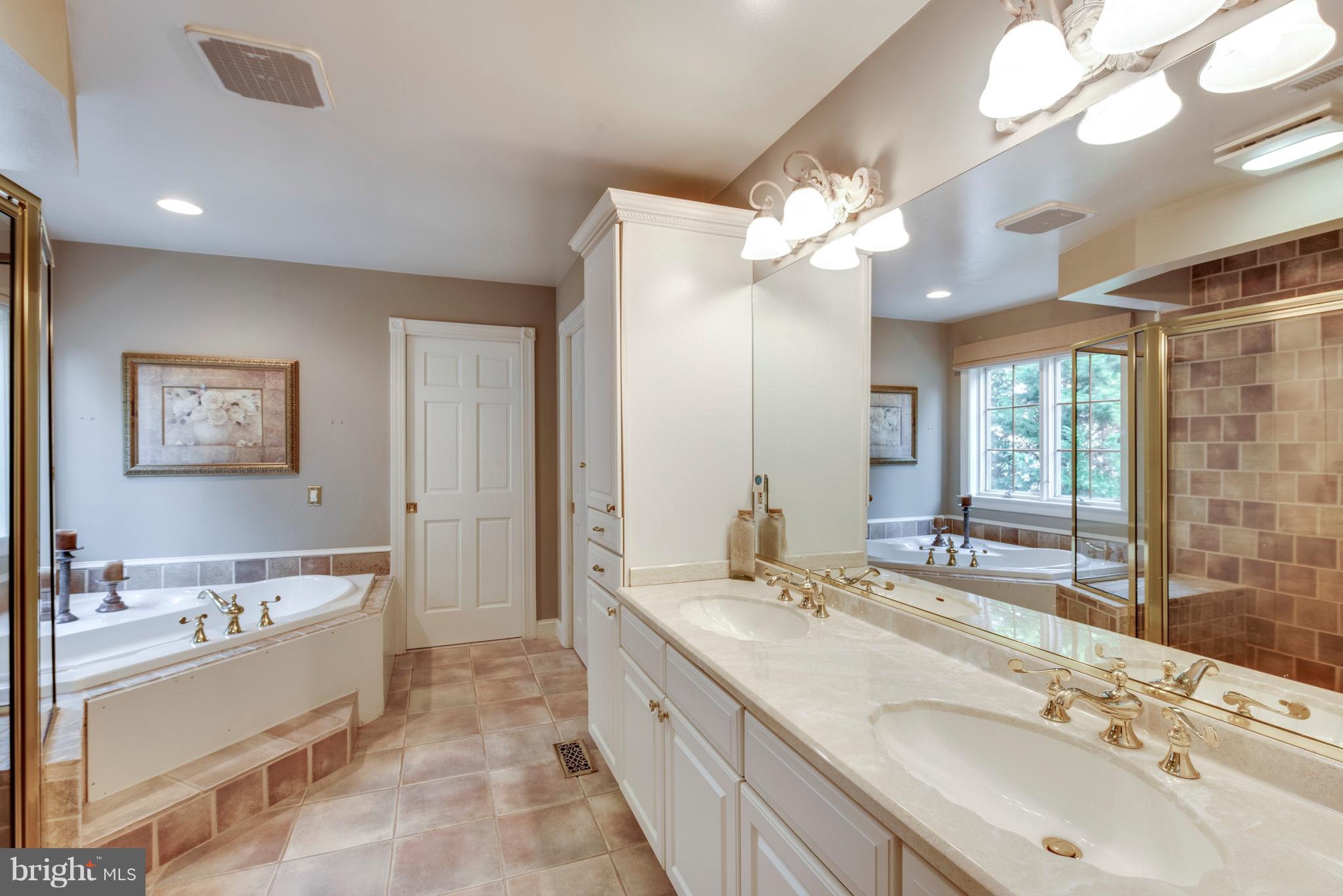 1795 Beachfield Road Annapolis, MD 21409 - Photo 42 of 49 a spacious bathroom with a double vanity sink mirror and a bathtub