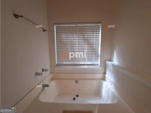 a bath tub sitting in a bathroom next to a window
