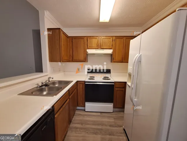 a kitchen with a sink stove and refrigerator