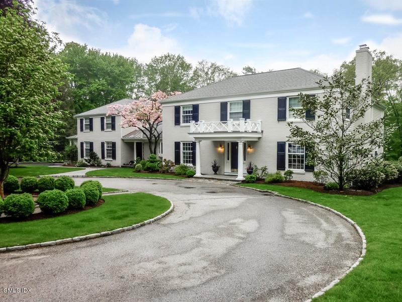 385 Middlesex Road Darien, CT 06820 - Photo 1 of 28 a front view of a house with a yard and garage