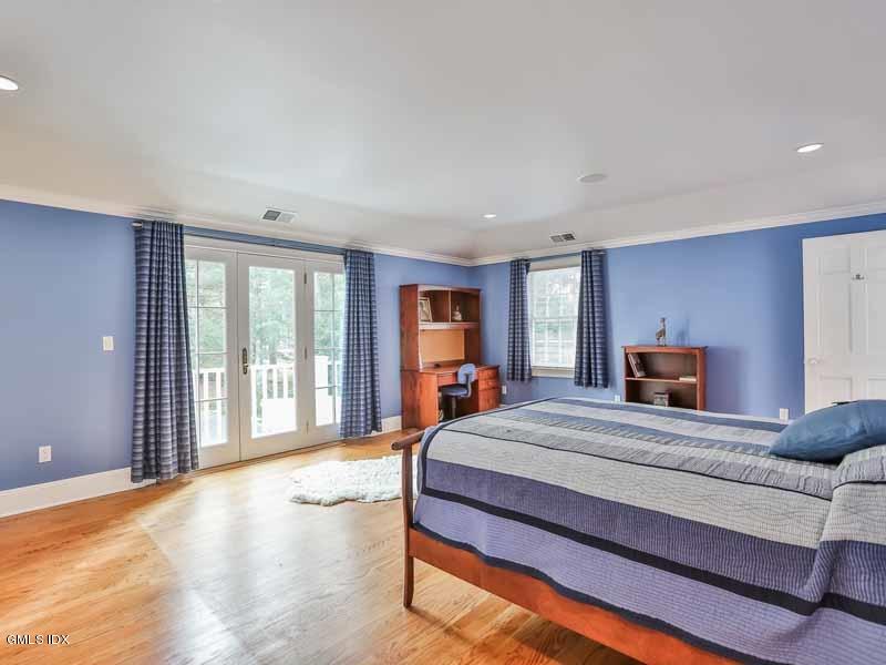385 Middlesex Road Darien, CT 06820 - Photo 17 of 28 a bedroom with a large bed and large windows