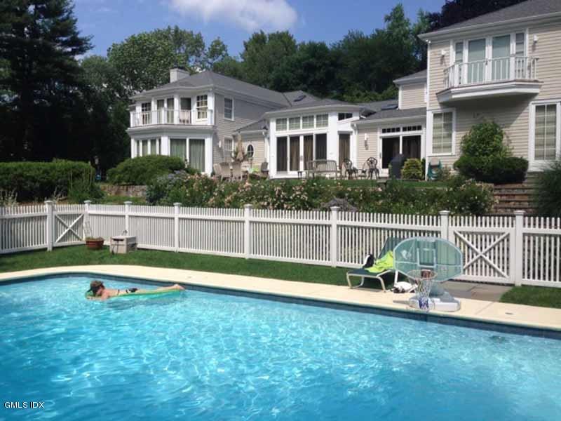 385 Middlesex Road Darien, CT 06820 - Photo 24 of 28 a view of a house with a backyard and a small yard