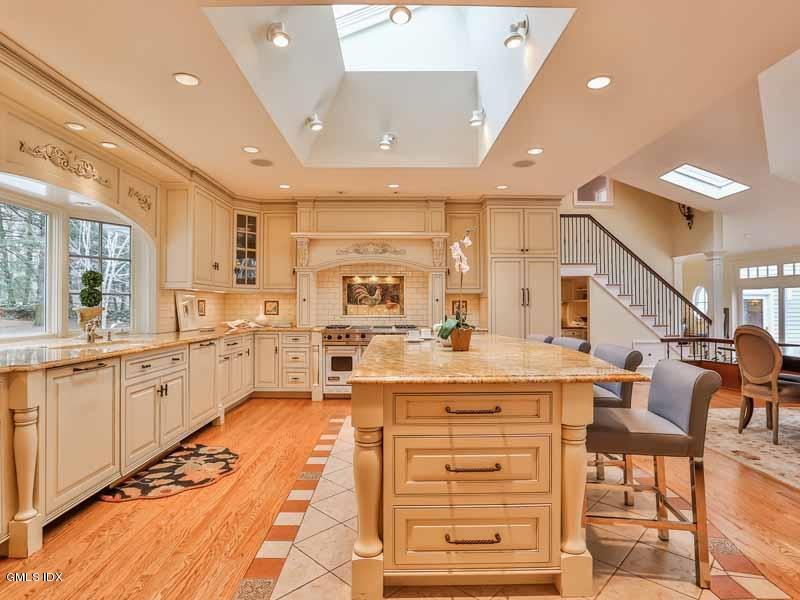 385 Middlesex Road Darien, CT 06820 - Photo 8 of 28 a large kitchen with stainless steel appliances kitchen island granite countertop a large room a stove and a refrigerator
