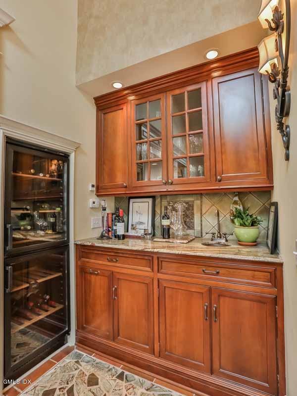 385 Middlesex Road Darien, CT 06820 - Photo 10 of 28 a kitchen with granite countertop wooden cabinets and white appliances