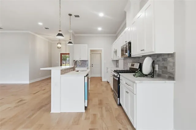 a kitchen with a sink a counter top space and cabinets