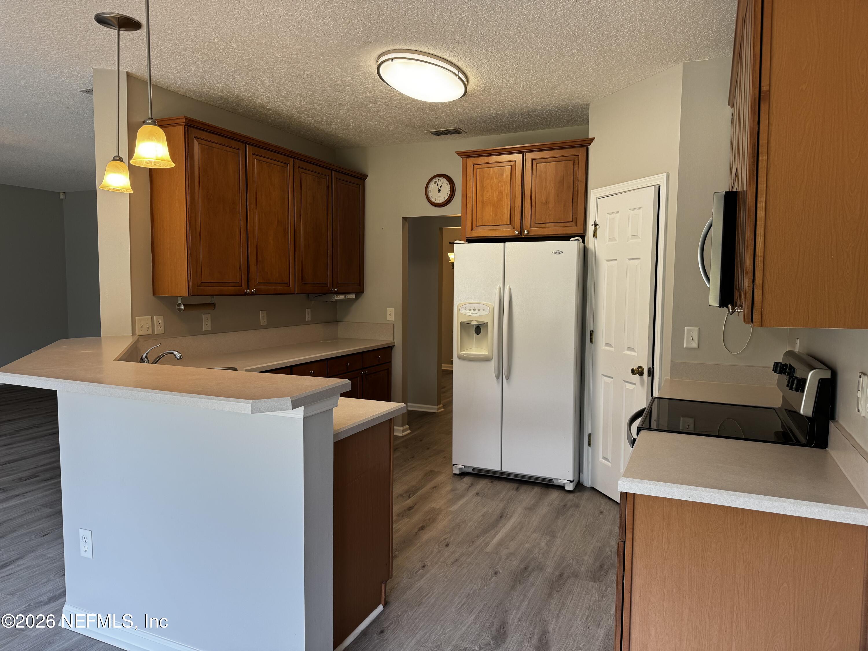 16255 Shellcracker Road Jacksonville, FL 32226 - Photo 20 of 40 a kitchen with a refrigerator a sink and cabinets
