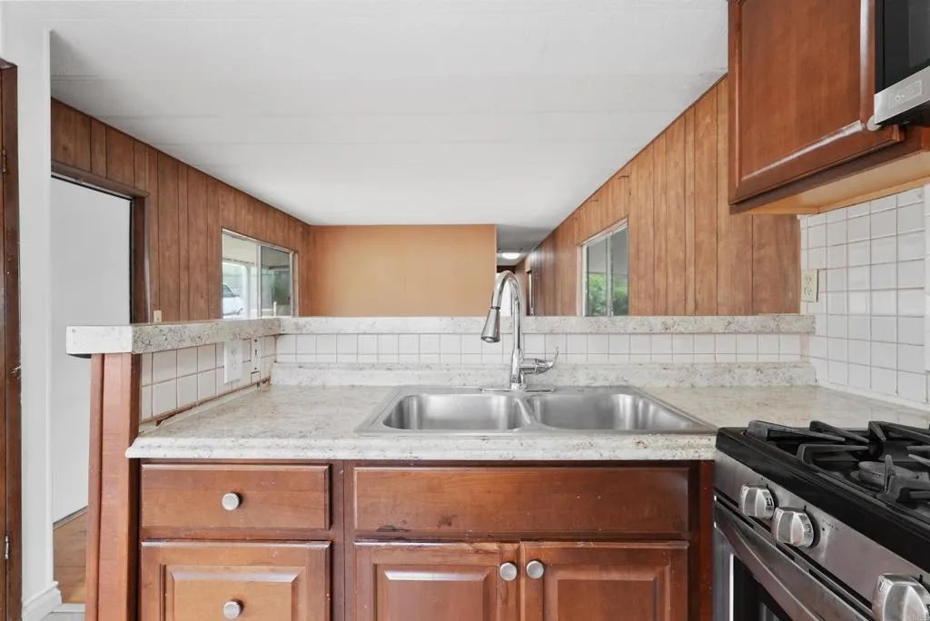 1455 Alturas Street, Unit 41 Fallbrook, CA 92028 - Photo 21 of 52 a kitchen with granite countertop a sink and a stove