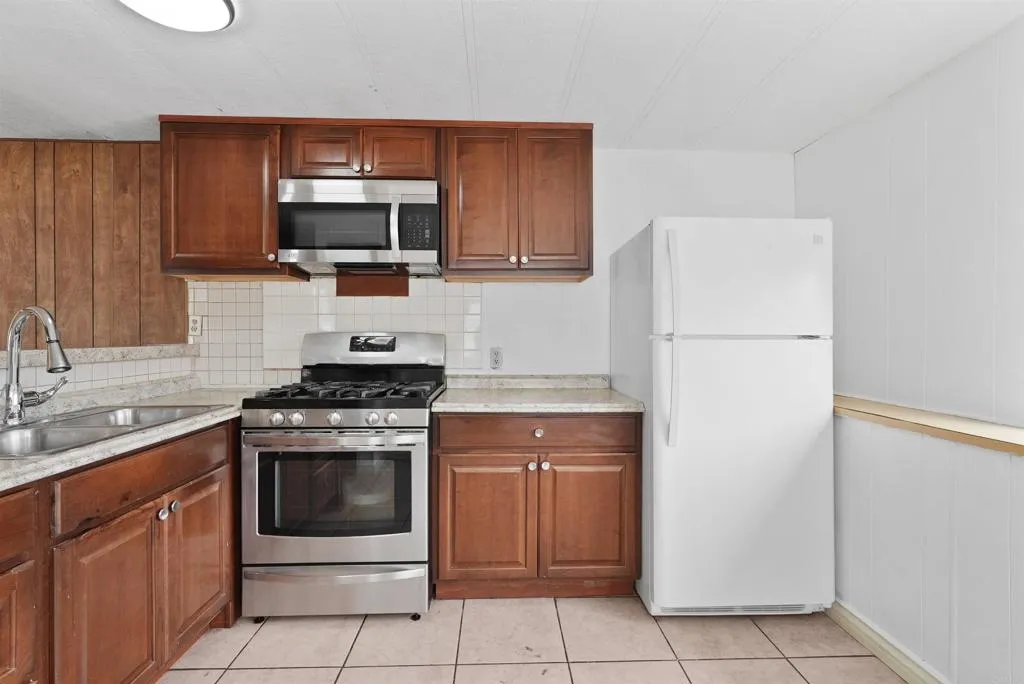 1455 Alturas Street, Unit 41 Fallbrook, CA 92028 - Photo 22 of 52 a kitchen with a stove microwave and refrigerator