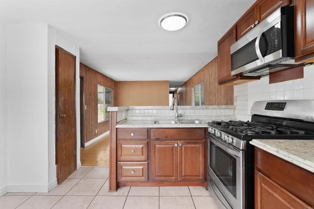 1455 Alturas Street, Unit 41 Fallbrook, CA 92028 - Photo 25 of 52 a kitchen with stainless steel appliances granite countertop a stove and a sink